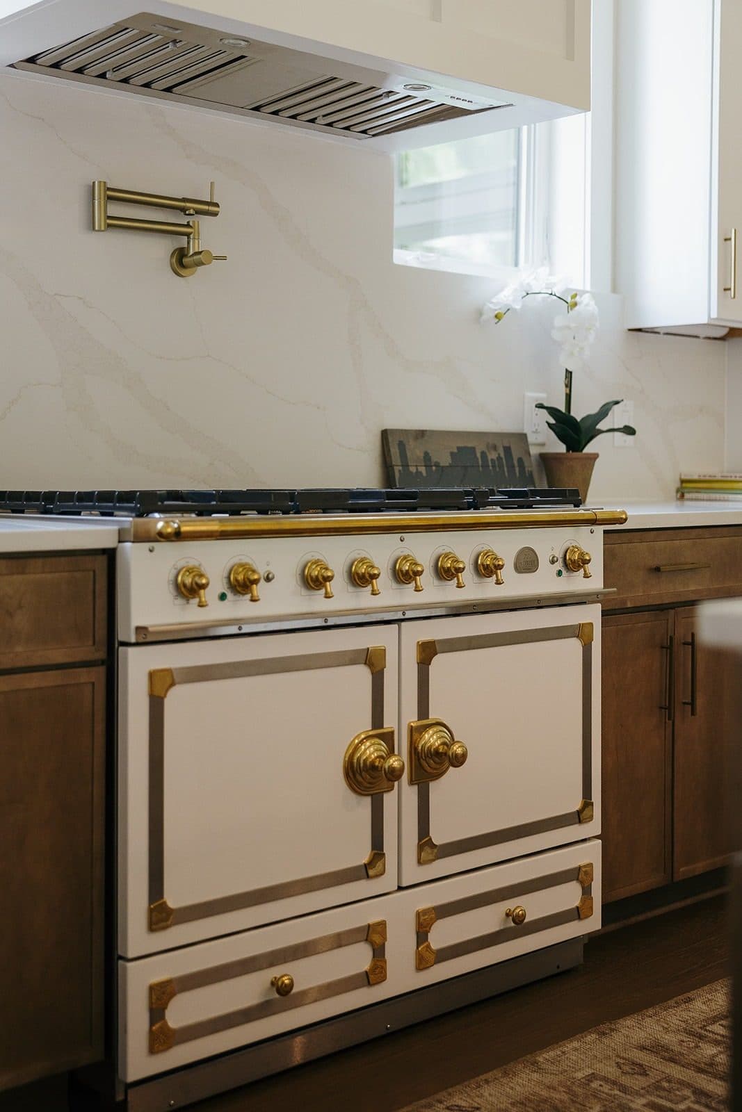 French range with brass hardware and marble backsplash from a Ryan Boggs listing