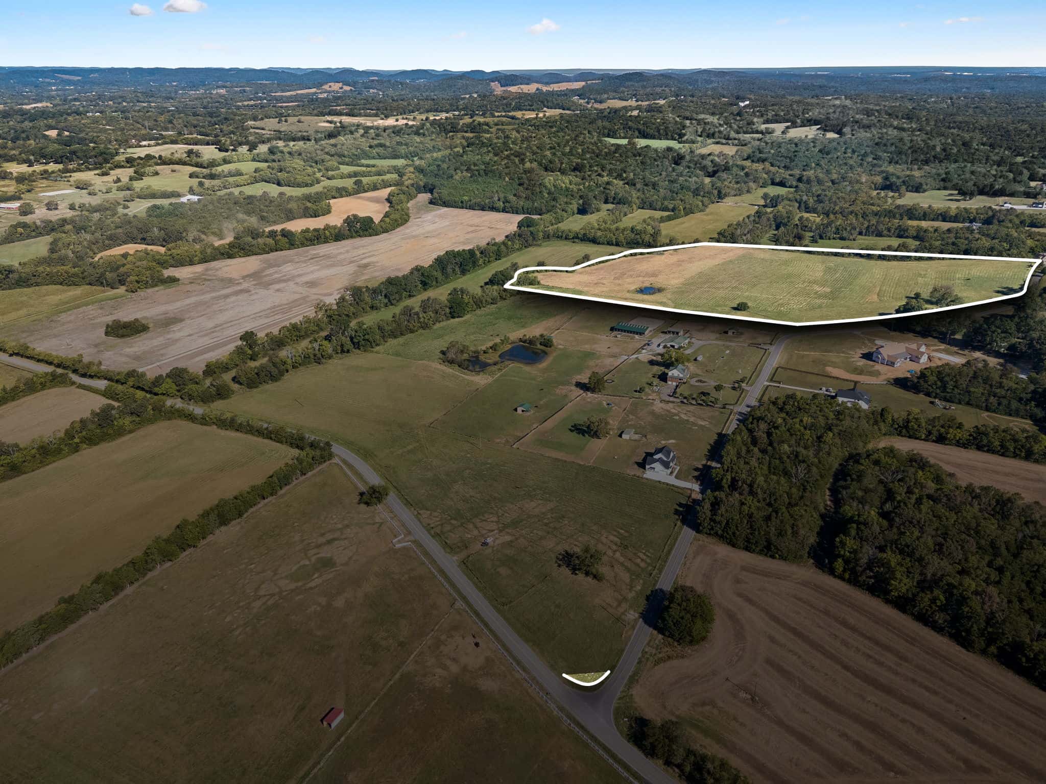 Aerial view of Tract 2 in College Grove, TN, outlined in white: the back field with its small pond along Rehobath Road