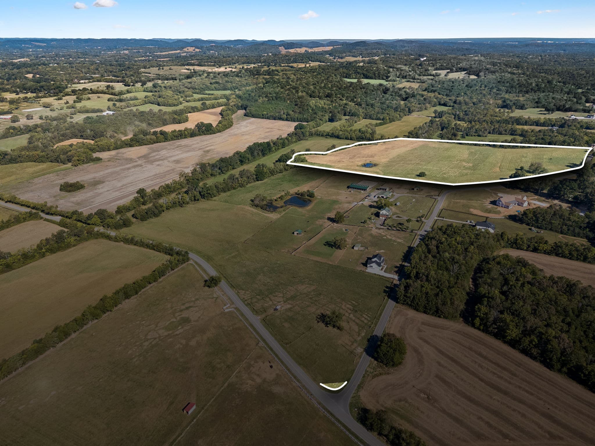 Aerial view of Tract 2 in College Grove, TN, outlined in white: the back field with its small pond along Rehobath Road