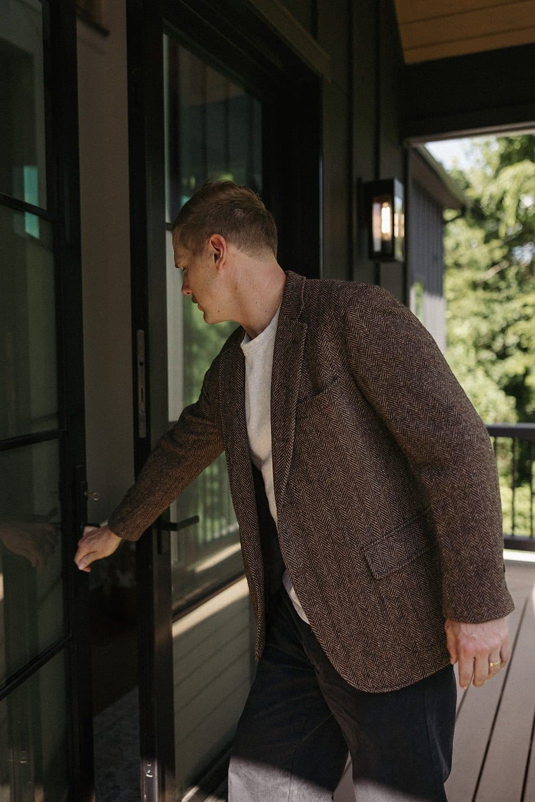 Ryan Boggs opening the steel front door of a luxury Williamson County listing