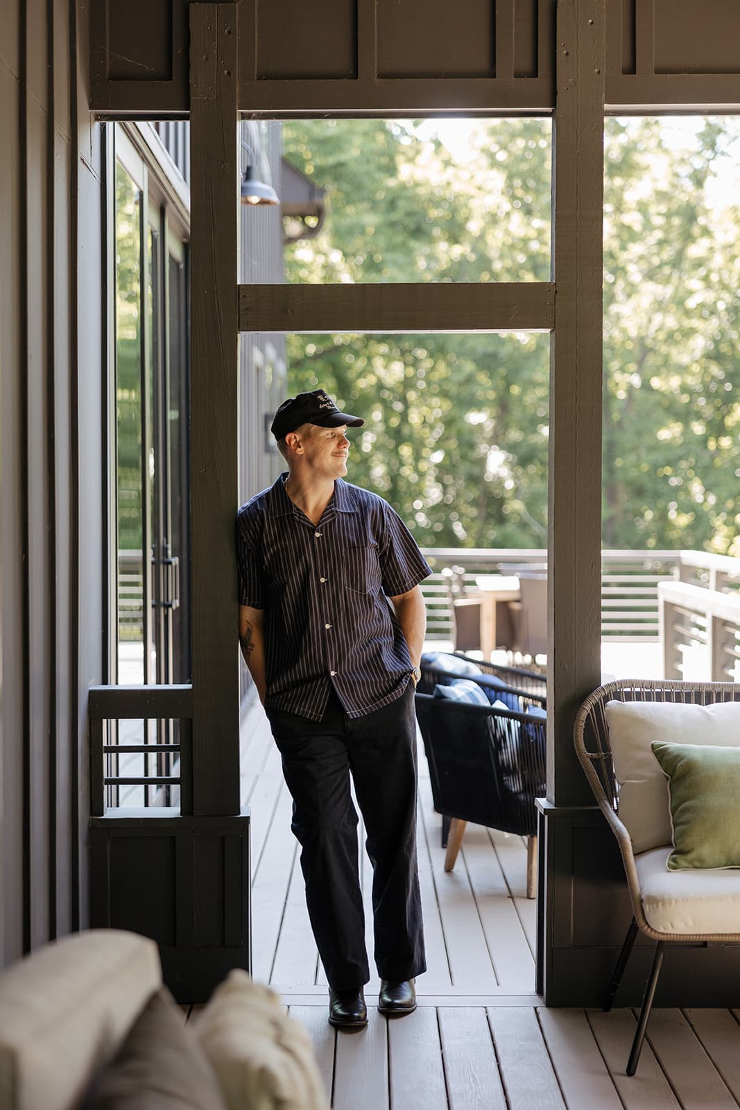 Ryan Boggs standing in a screened porch doorway, smiling